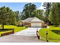 A charming brick home with lush landscaping and a long driveway at 1478 Bluegil Dr., Longs, SC 29568