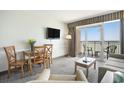 Inviting living room with balcony showcasing ocean views with seating at 2000 N Ocean Blvd. # 1810, Myrtle Beach, SC 29577