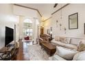 Open living area with high ceilings, hardwood floors, comfortable sofas, and decor, bathed in natural light at 203 Old Hickory Dr., Conway, SC 29526