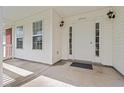 Covered front porch with white pillars, windows, and house number above the front door at 2965 Mount Olive Rd., Loris, SC 29569