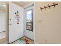 Entryway with a welcome sign, coat hooks, and a view through the screen door at 305 Hillside Dr. N # 205, North Myrtle Beach, SC 29582
