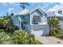 Two-story home with blue siding, white trim, a two-car garage and lush landscaping at 305 Splendor Circle, Murrells Inlet, SC 29576