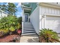 Inviting front porch with stairs, black and white risers, and a 'HOME' sign at 305 Splendor Circle, Murrells Inlet, SC 29576
