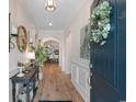 Inviting entryway with stylish decor, hardwood floors, and decorative wreath on the front door at 3185 Viceroy Loop, Little River, SC 29566