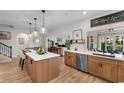 Bright kitchen with an island, stainless steel appliances, and a view into the living and dining areas at 3185 Viceroy Loop, Little River, SC 29566