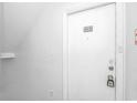 Close up of the unit entrance featuring a white door with black numbering on a white wall at 3700 Golf Colony Lane # 25-D, Little River, SC 29566