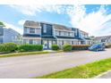 Charming condo exterior featuring well-manicured landscaping and ample parking space at 3700 Golf Colony Lane # 2-J, Little River, SC 29566