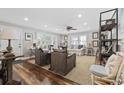 Bright and spacious living room featuring hardwood floors, neutral tones, and multiple seating areas at 412 Middleton Dr., Pawleys Island, SC 29585