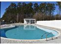 Community pool with blue water, lounge chairs and a white fence is great for summer time enjoyment at 419 White Willow Way, Longs, SC 29568