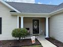 Welcoming front porch with decorative columns and a cheerful 'Hello Summer' sign at 429 Oakham Dr., Conway, SC 29526