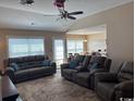 Comfortable living room featuring plush seating and abundant natural light through large windows at 429 Oakham Dr., Conway, SC 29526