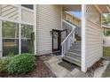 Home entrance with decorative wreath on the door, open stairs, and lush landscaping at 4450 Little River Inn Ln. # 601, Little River, SC 29566