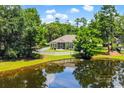 Picturesque backyard with a pond view, white picket fence, and screened-in porch at 4499 Firethorne Dr., Murrells Inlet, SC 29576