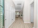 Inviting foyer with light wood floors, decorative wall paneling, and open view into the living spaces at 5018 Oat Fields Drive, Myrtle Beach, SC 29588