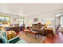 Cozy living room and dining area with bright, natural light, wood paneled walls and brick floors at 506 28Th Ave. N, Myrtle Beach, SC 29577