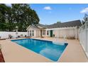 Backyard view of a refreshing swimming pool, patio space and a white pergola at 556 Crusade Circle, Conway, SC 29526