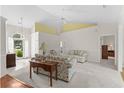 Bright living room featuring neutral tones, vaulted ceilings, and carpet flooring at 583 Wildflower Trail, Myrtle Beach, SC 29579