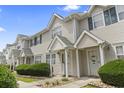 Inviting townhouse exterior with well-maintained landscaping and neutral siding at 611 2Nd Ave. S # 18-C, North Myrtle Beach, SC 29582