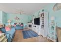 Bright living room with cozy seating, a fireplace, and beachy decor at 614 14Th Ave. S # 47, Surfside Beach, SC 29575