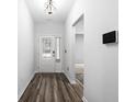 Inviting entryway with paneled door, wood-look floors, and modern wall-mounted security system at 628 Mccorkle Place, Conway, SC 29526