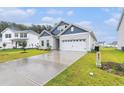 Attractive home with manicured lawn, blue accent siding, and a pristine two-car garage at 628 Mccorkle Place, Conway, SC 29526