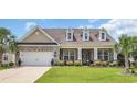 Inviting brick house with dormer windows and a manicured front yard at 698 Lafayette Park Dr., Little River, SC 29566