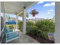 Inviting porch with comfortable seating and vibrant hanging plants, perfect for enjoying peaceful outdoor moments at 914 Mary Read Dr., North Myrtle Beach, SC 29582