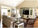 Comfortable living room with vaulted ceilings, a cozy sofa, entertainment center, and view of other living spaces at 9614 Indigo Creek Blvd., Murrells Inlet, SC 29576