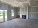 Unfinished living room with fireplace, sliding glass doors and bright window at 985 Oak Hollow St., Longs, SC 29568