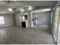 Spacious living room showing laminate floors, fireplace, and view into the kitchen area at 9888 Conifer Ln., Murrells Inlet, SC 29576