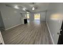 Open living room with vaulted ceilings, a fireplace, and sliding glass doors to the backyard at 9888 Conifer Ln., Murrells Inlet, SC 29576