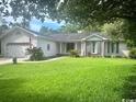 Charming home with a well-manicured lawn and an attached two-car garage at 1150 Waterway Dr., Myrtle Beach, SC 29572