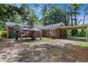 A spacious backyard includes a tented gathering space, and a covered carport adding functionality and charm at 1217 S Highway 501, Marion, SC 29571