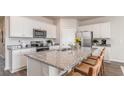 Modern kitchen with stainless steel appliances, granite countertops, ample white cabinetry, and seating at the island at 1407 Nokota Dr., Conway, SC 29526