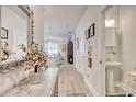 Hallway featuring decoratively adorned walls and leading into an open kitchen and living area at 160 Juniata Loop, Little River, SC 29566