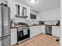 Bright kitchen features stainless steel appliances, sleek white cabinets, and modern countertops at 2196 Liberty Circle, Little River, SC 29566