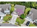 An aerial perspective showcases the property's manicured lawn, charming curb appeal, and neighborhood at 2199 Birchwood Circle, Myrtle Beach, SC 29577