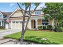 Inviting two-story home with a manicured lawn, an attached two-car garage, and a cozy front porch at 2199 Birchwood Circle, Myrtle Beach, SC 29577