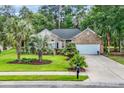 Well-maintained brick home features a lush lawn and mature landscaping, creating inviting curb appeal at 327 Trestle Way, Conway, SC 29526