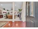 Inviting foyer with hardwood floors offers a view of the open-concept living space at 327 Trestle Way, Conway, SC 29526