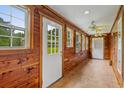 Hallway with wood paneling, tile floors, and lots of natural light at 3534 Nichols Hwy., Galivants Ferry, SC 29544