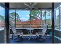 Cozy screened porch with chairs and a table, perfect for enjoying the view and fresh air at 415 Ocean Creek Dr. # 2373, Myrtle Beach, SC 29572