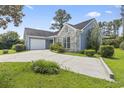 Inviting single-story home boasting a two-car garage, neat landscaping, and a long driveway for ample parking at 4197 Friendfield Trace, Little River, SC 29566