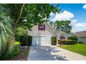 Home with an attached garage and a well maintained lawn and landscape at 4570 Fringetree Dr., Murrells Inlet, SC 29576