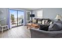 Bright living room with a sliding glass door to balcony and a comfortable seating area at 5905 South Kings Hwy. # A337, Myrtle Beach, SC 29575