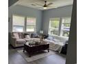 Bright living room featuring large windows, hardwood flooring, and comfortable couches with throw pillows at 613 Todd Blvd., Conway, SC 29526