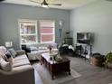 Inviting living room with modern furnishings, plush sofas, decorative pillows, and a ceiling fan at 613 Todd Blvd., Conway, SC 29526