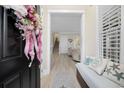 Bright foyer with a bench, decorative pillows, and a glimpse into the living spaces at 721 Mckinley Way, Myrtle Beach, SC 29577