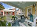Inviting front porch featuring rocking chairs, a ceiling fan, and a view of the neighborhood at 721 Mckinley Way, Myrtle Beach, SC 29577