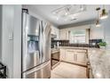 Modern kitchen featuring stainless steel appliances, including a refrigerator and range, complemented by white cabinets at 10056 Kings Rd., Myrtle Beach, SC 29572